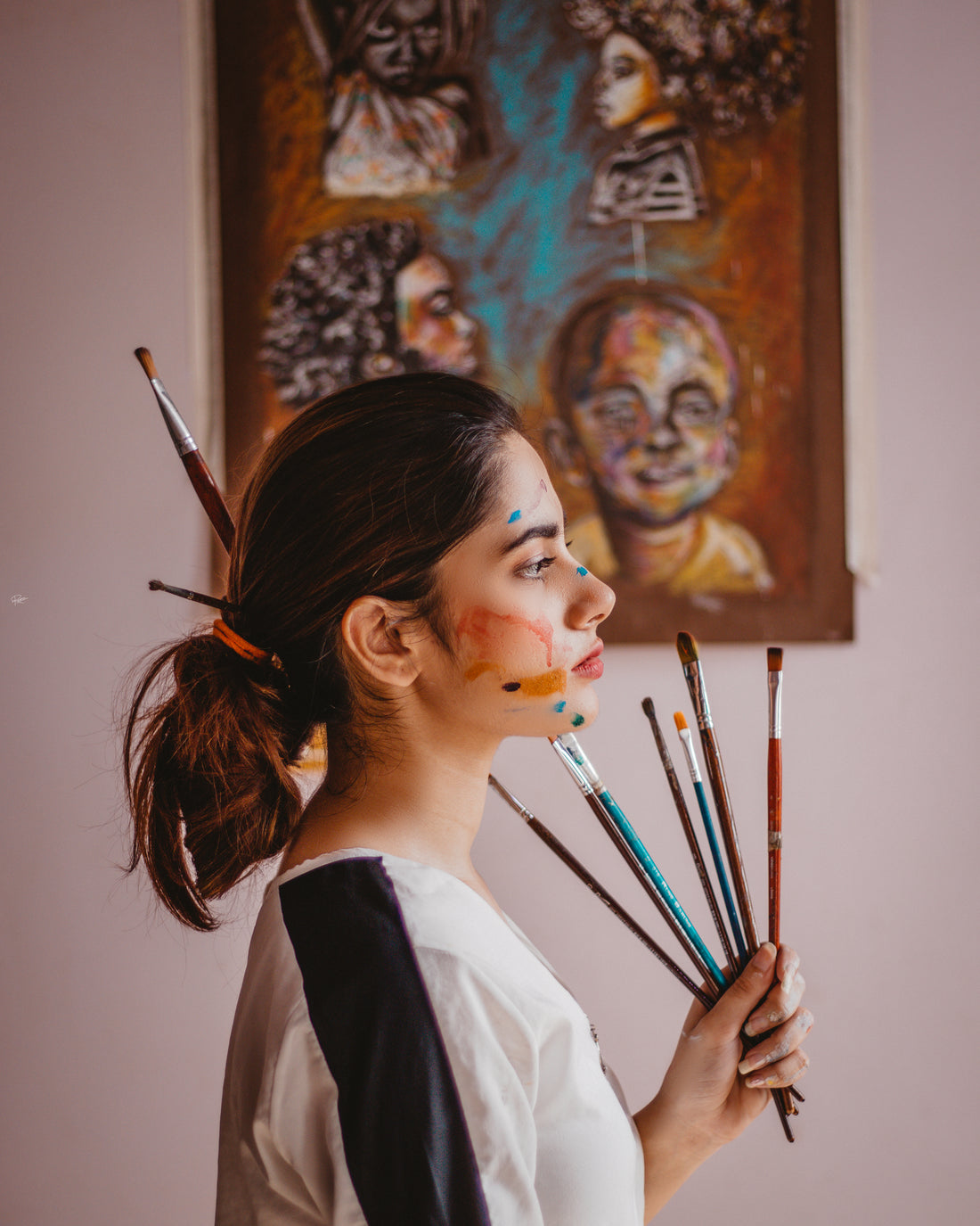a female artist with her paint brushes