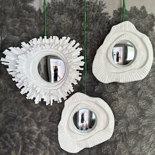 three plaster wall mirror on a scenic wallpaper